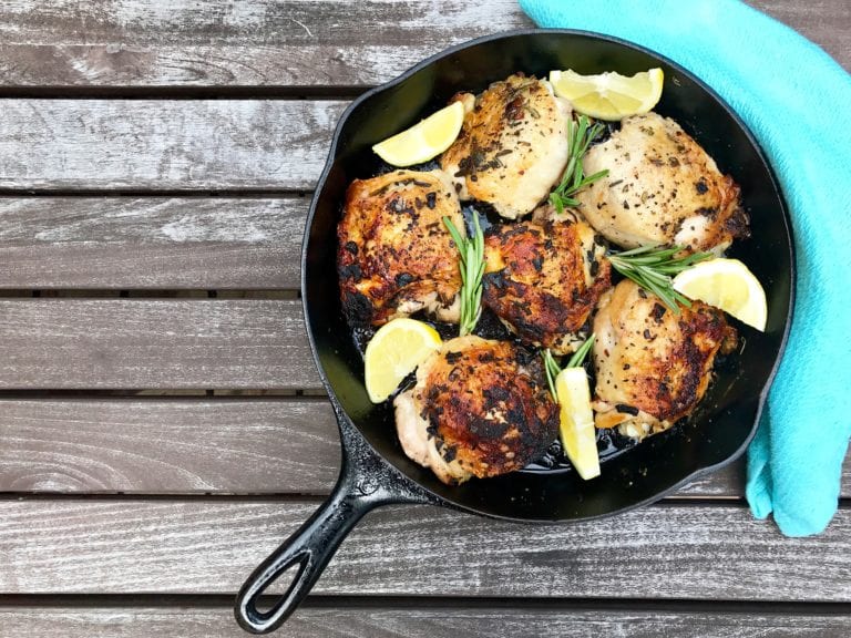 crispy cast iron chicken thighs with garlic, rosemary, and lemon slices