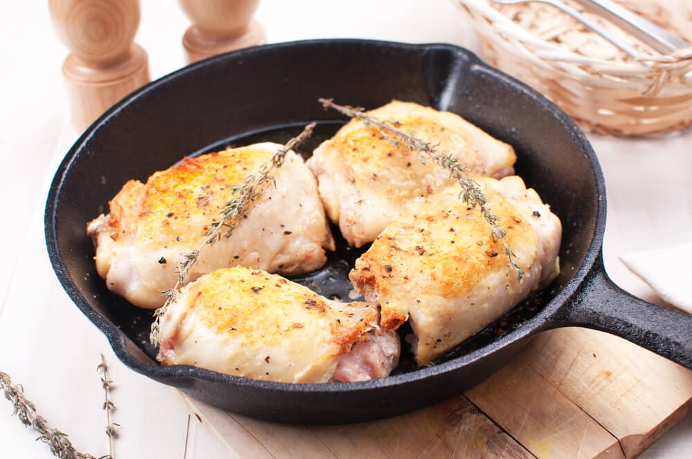 garlic rosemary chicken thighs in cast iron skillet