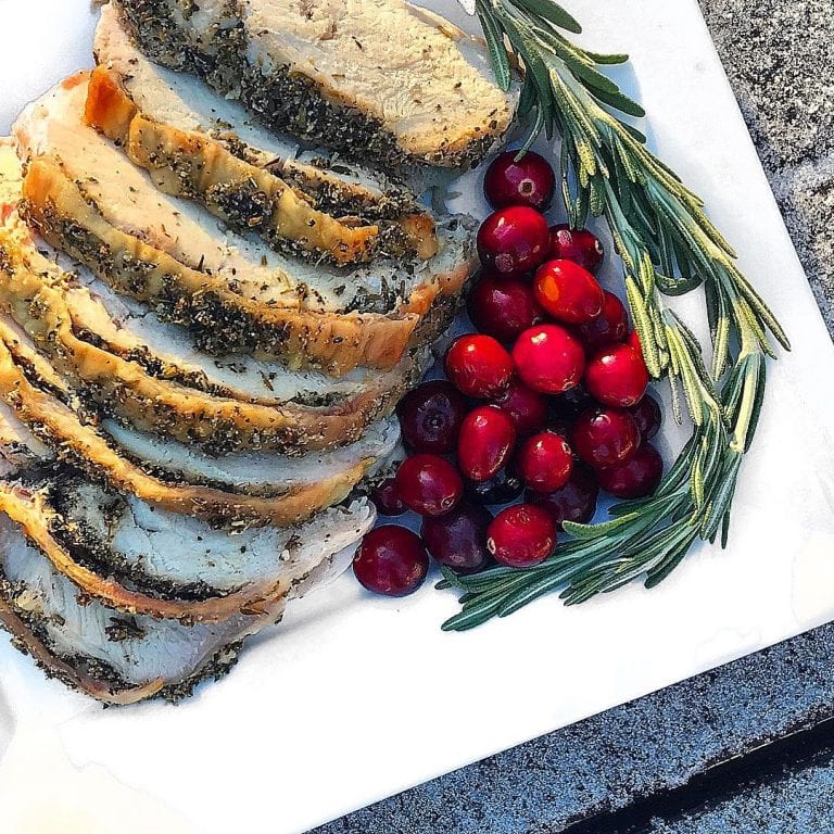 plate of garlic and herb roasted turkey breast with cranberries