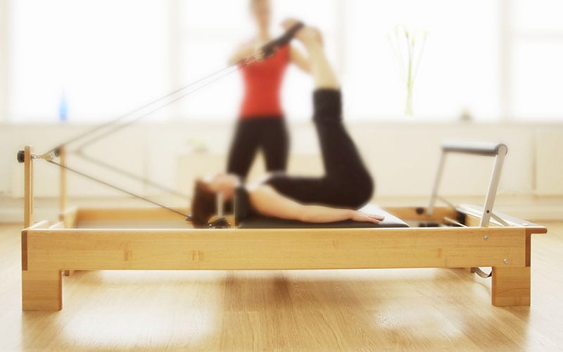 Pilates instructor and student doing Pilates movement
