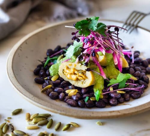 vegetarian tamales with pepita sauce and black beans