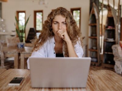 Woman holding normal lab results and still feeling exhausted