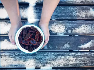child holding bowl of honey toasted pecans